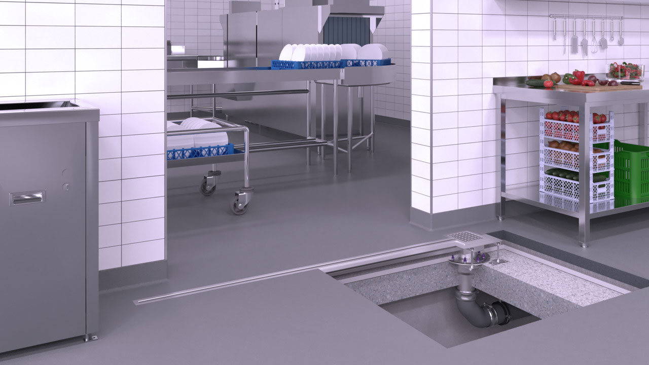 Exemple d'installation d'un caniveau à fente en acier inoxydable dans un passage d'une cuisine industrielle