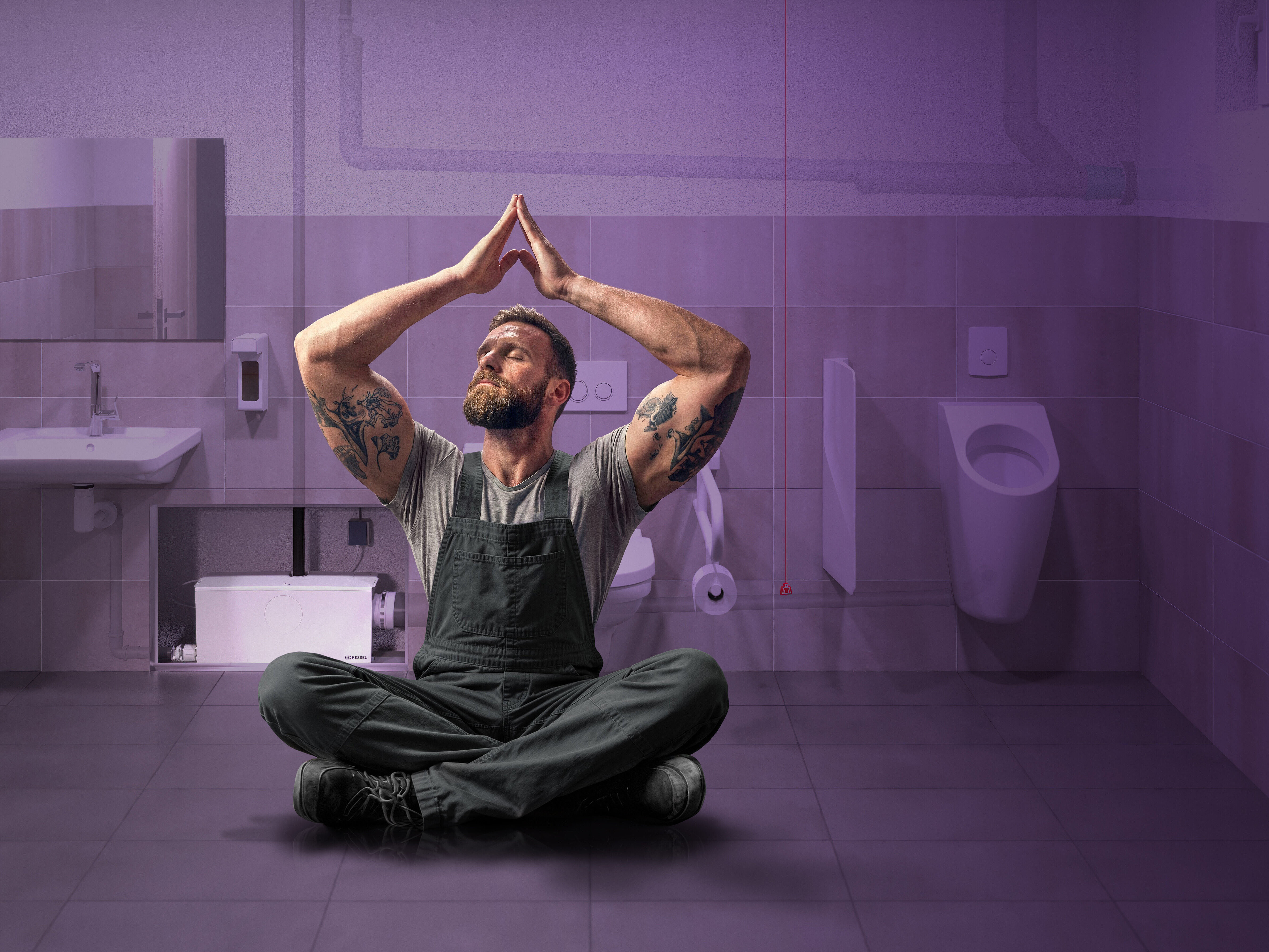 Un artisan détendu dans des toilettes publiques, avec un système de double chasse d'eau en arrière-plan.