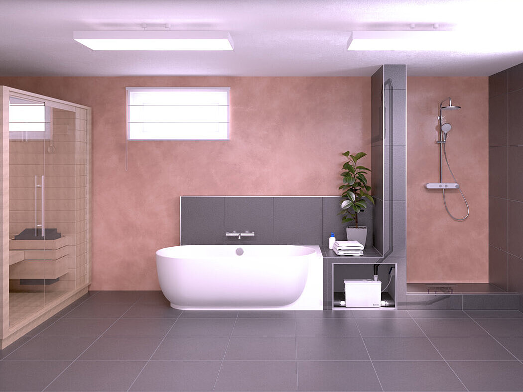 Sous-sol avec sauna, baignoire et douche. Les appareils sanitaires sont raccordés à un petit poste de relevage.
